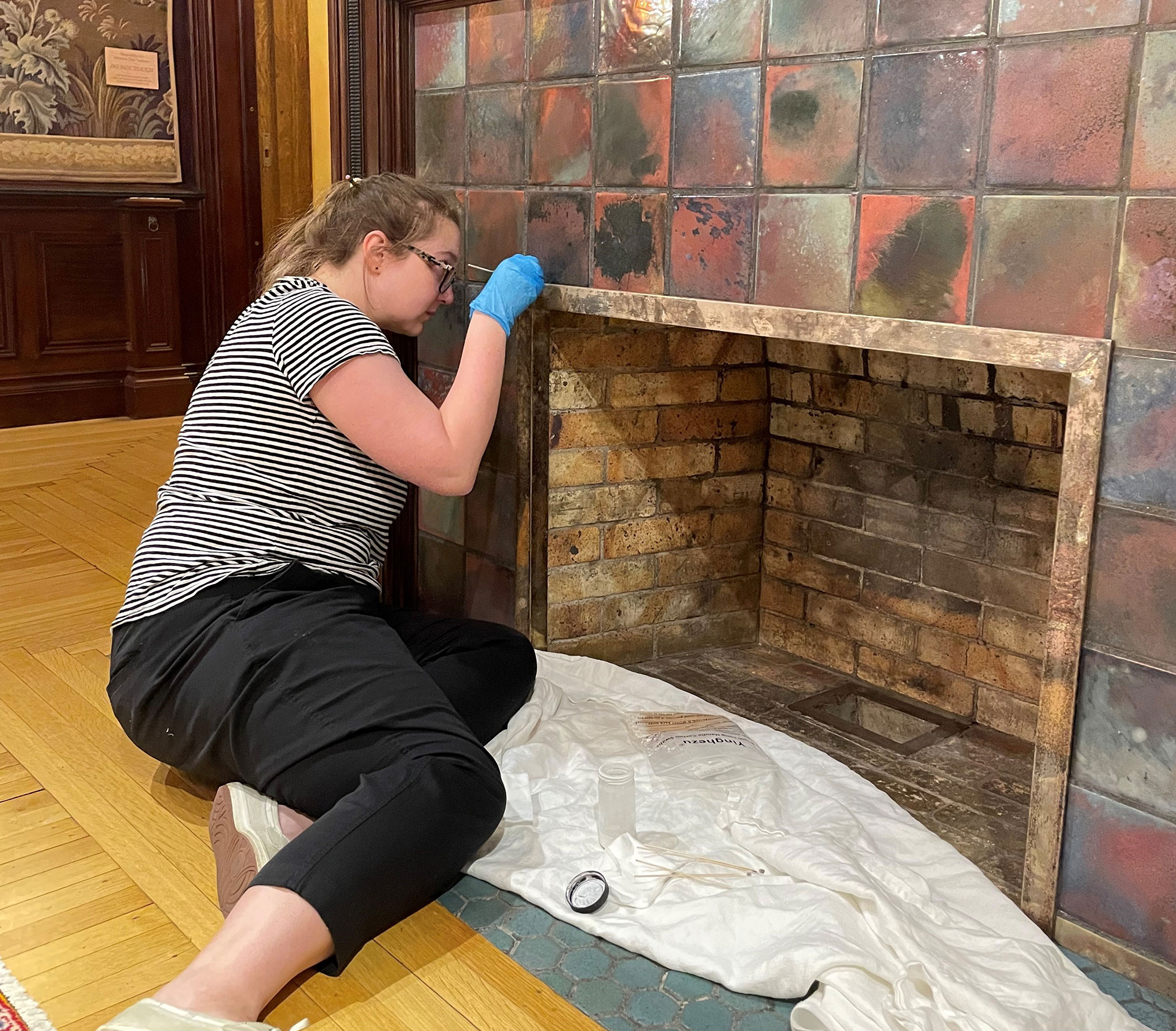 Oshkosh Public Museum staff member in the Historic Sawyer Home dining room