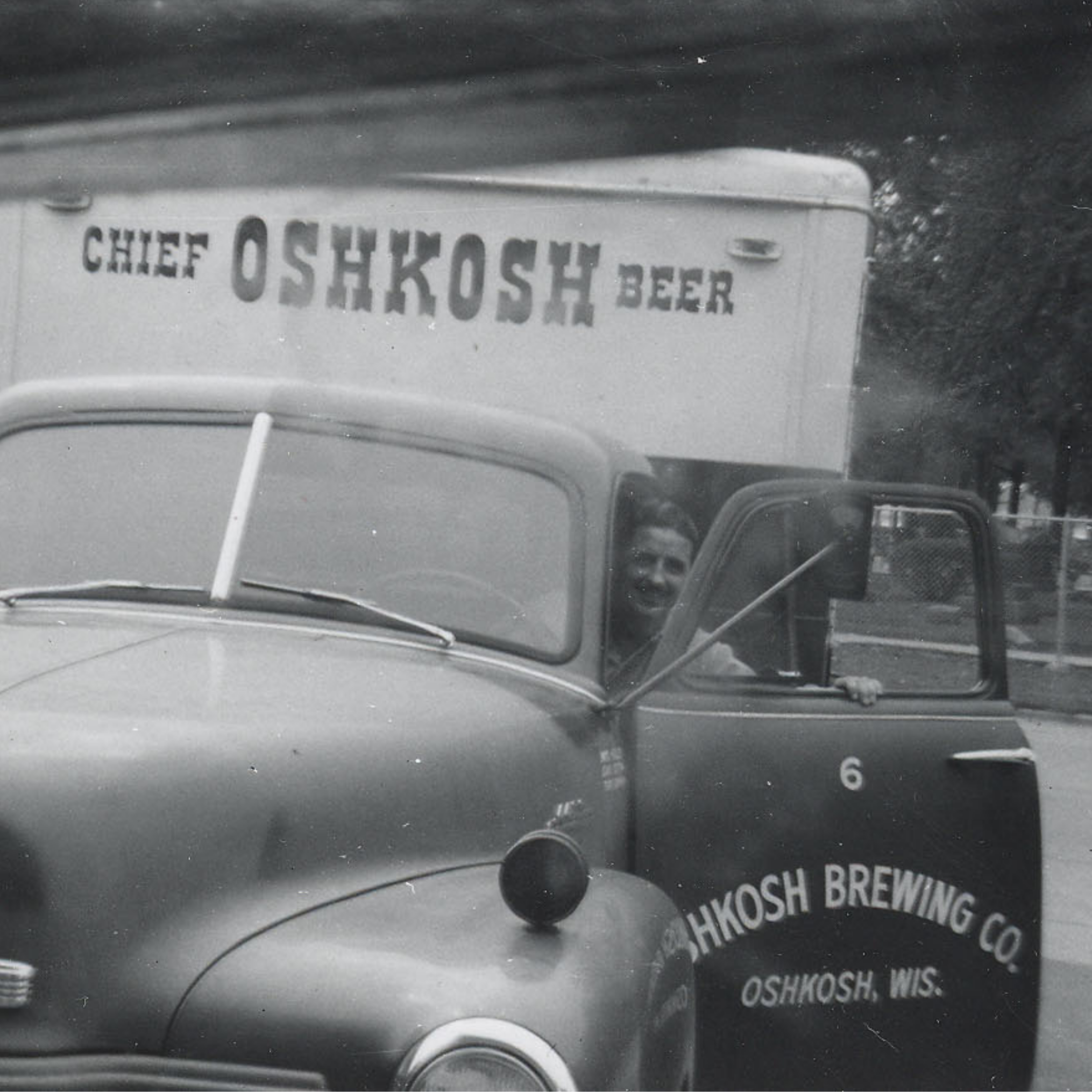 Candid photo of Oshkosh Brewing Company delivery driver Richard E. Safford stepping out of his truck.