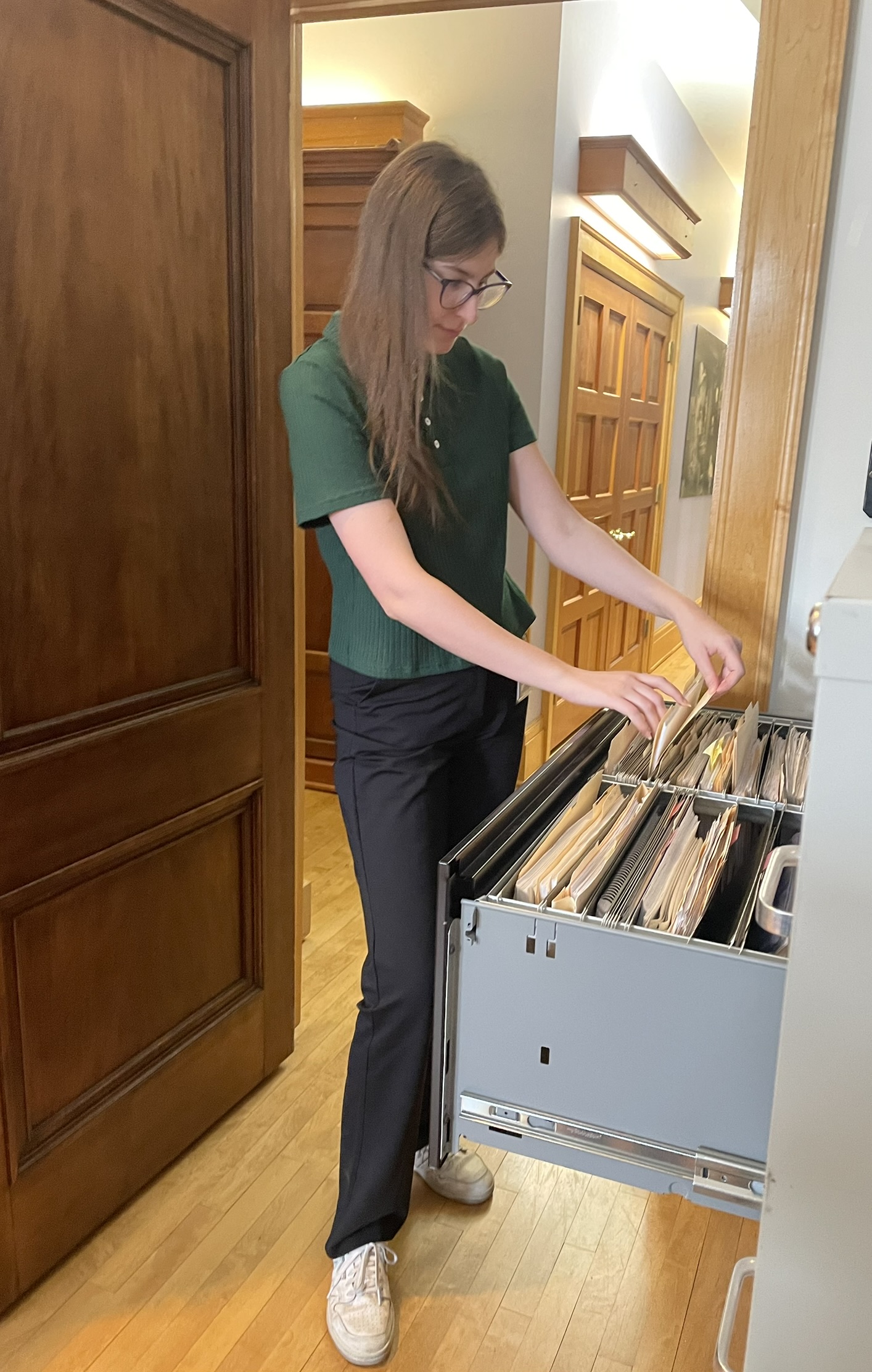NAGPRA Collections Assistant, Grace, filing paperwork