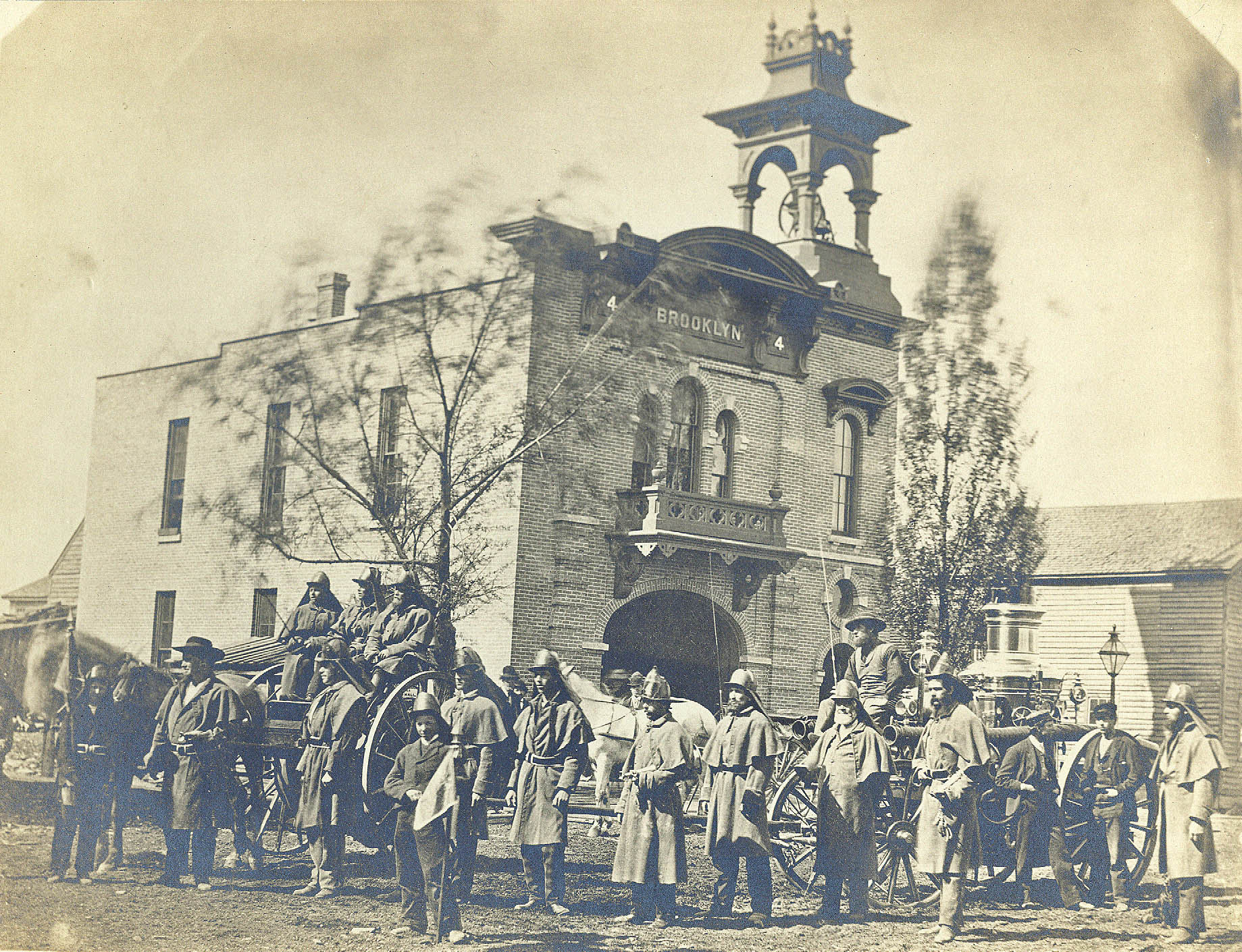 Firefighters gathered at the Brooklyn Fire House in Oshkosh, circa 1872.