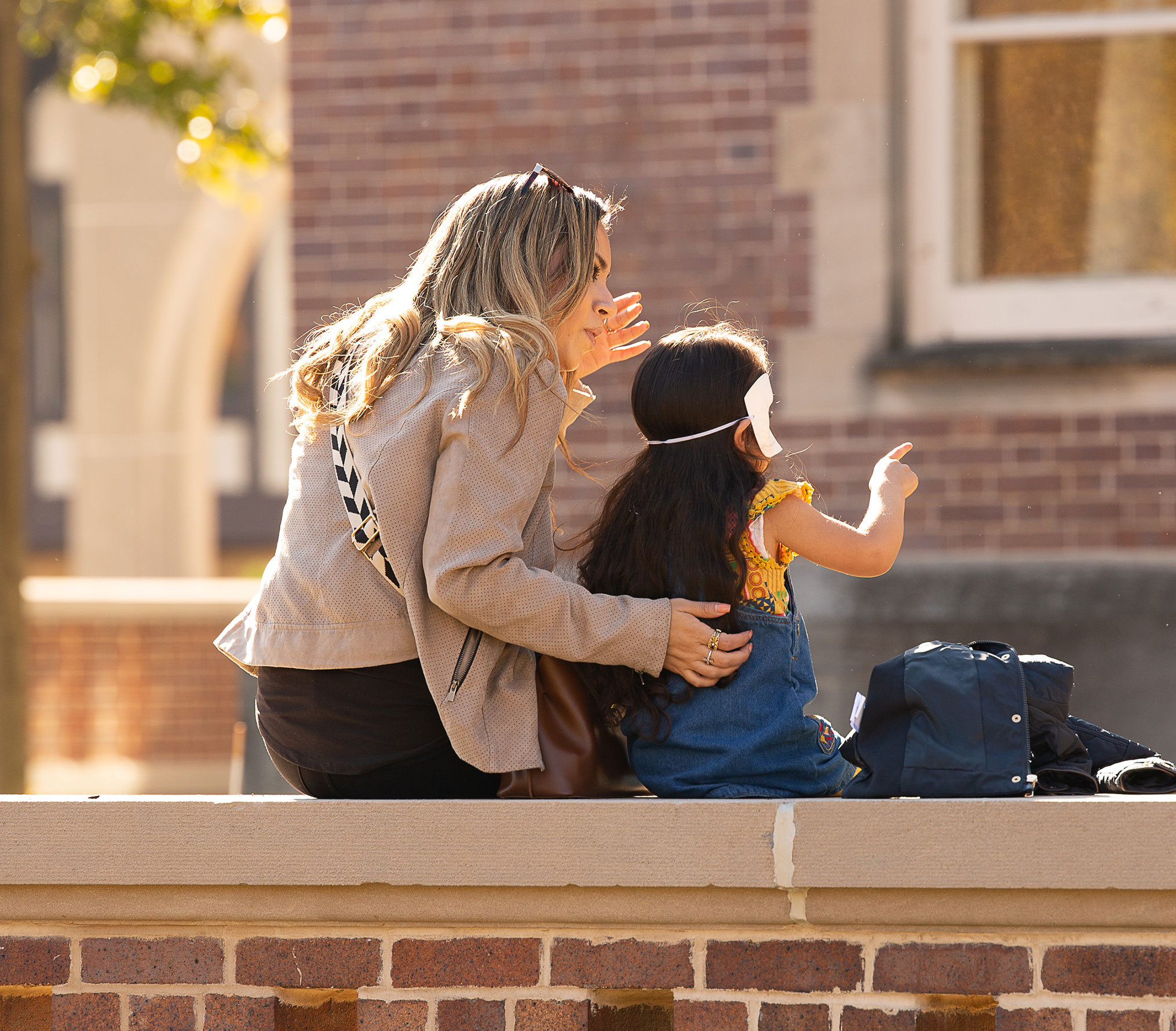 Mother and daughter sitting outside the Oshkosh Public Museum